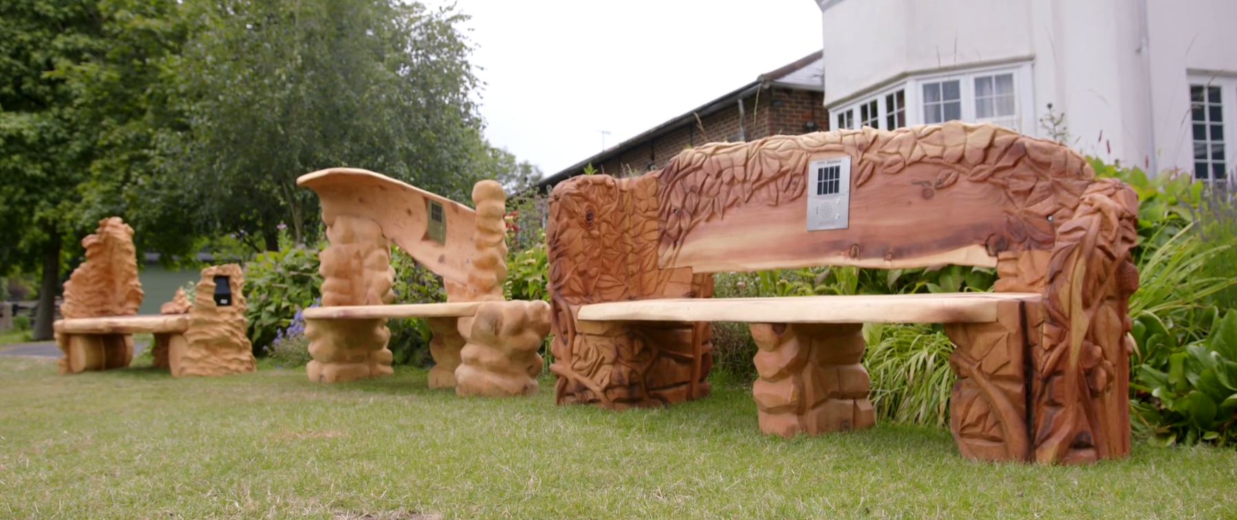 Three wooden carved benches, designed by Orpheus students