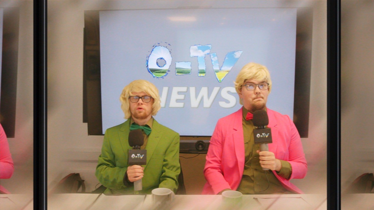Students performing in O-TV as news presenters