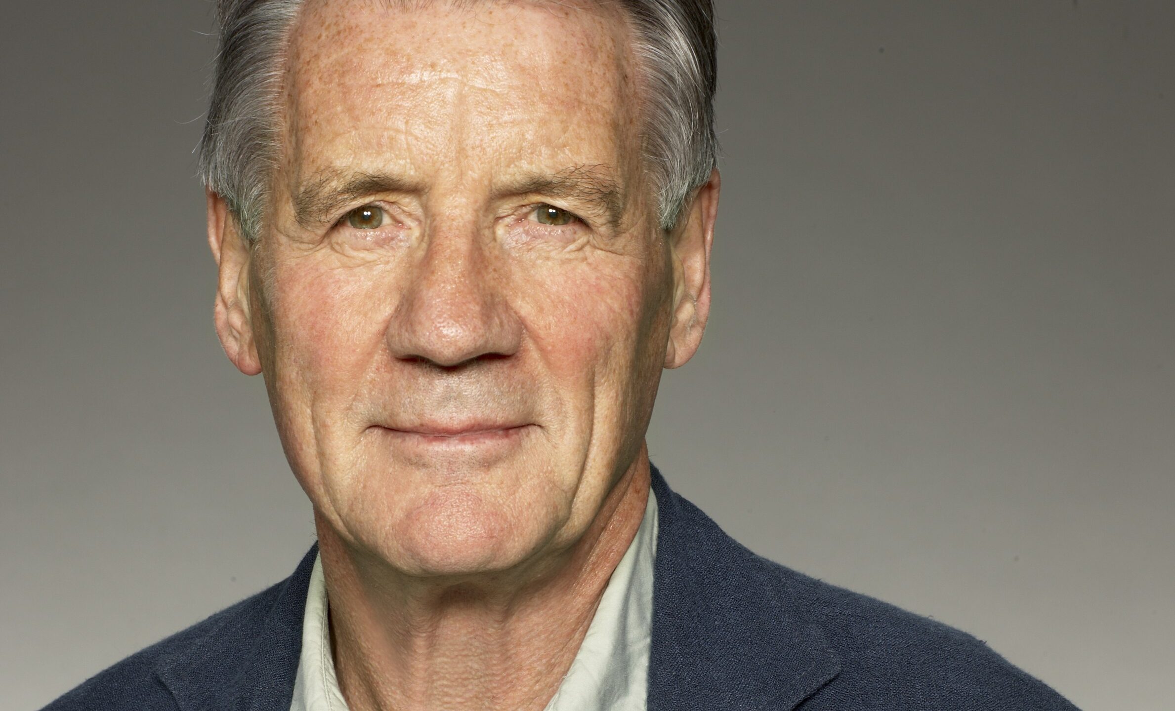 Sir Michael Palin smiling to the camera