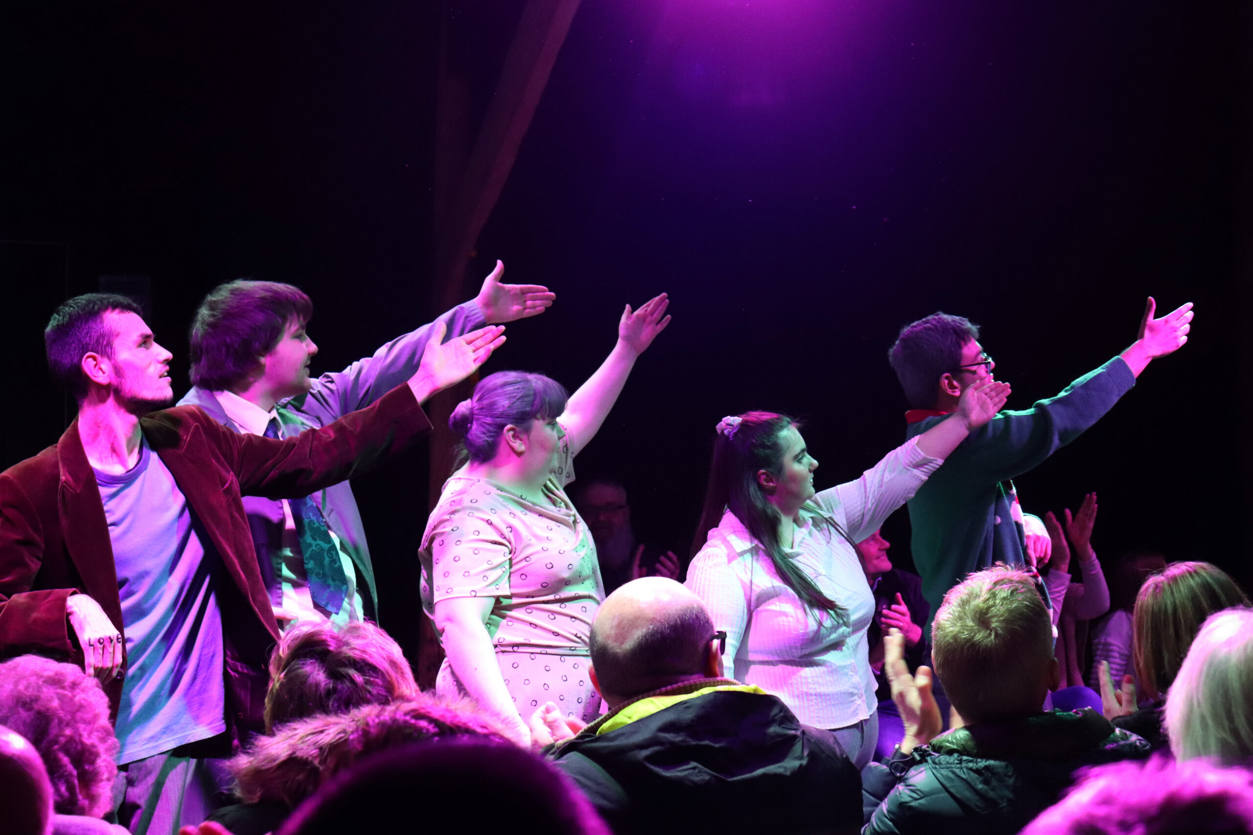 5 Orpheus students stood in front of each other, performing to an audience in the Orpheus Barn theatre