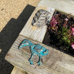 Sensory Bench/Flower box with tactile ornaments.